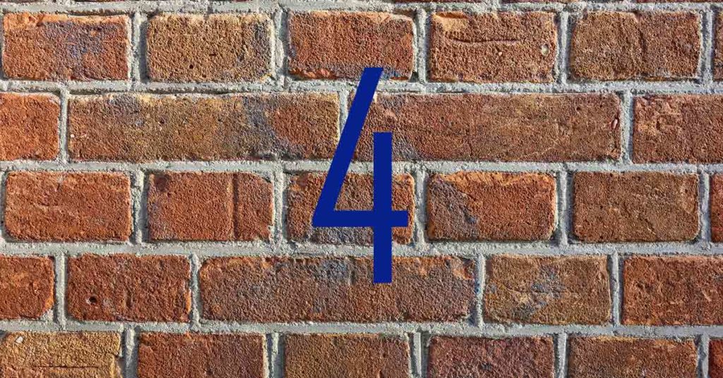 Blaue Zahl Vier vor roter Backsteinmauer - Immobilienfinanzierung